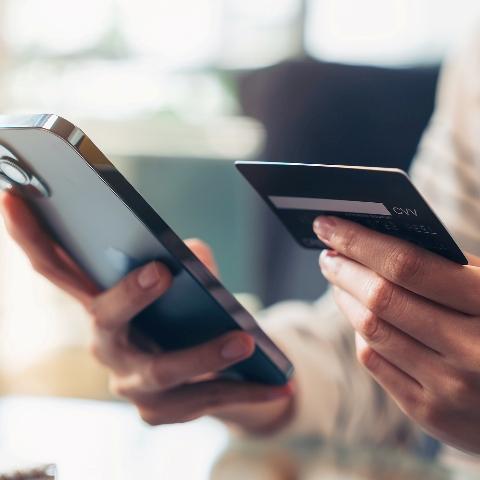 A customer using a credit card on a smart phone.