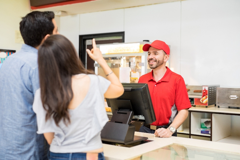 Customers ordering fast food at a QSR Ordering counter